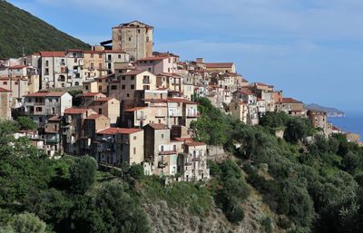 Buildings in town against sky