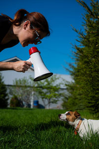 Woman with dog on field