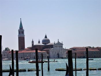 View of building by sea against clear sky