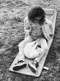 High angle view of woman sitting on field