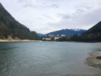 Scenic view of lake by trees against sky