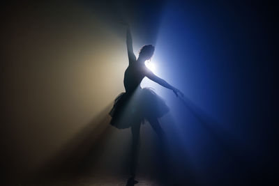 Silhouette ballet dancer dancing on stage