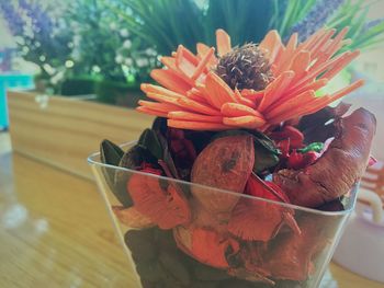 Close-up of orange flower pot on table