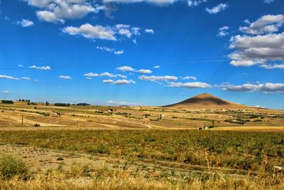 Scenic view of field against sky mountain brown and blue