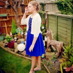 Full length of girl looking away while standing on field