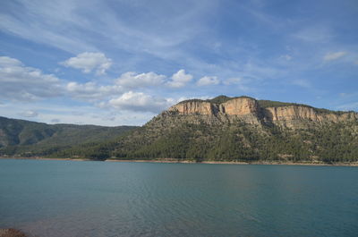 Scenic view of mountains against cloudy sky