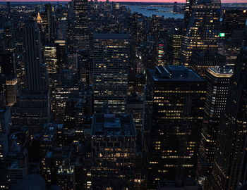 Aerial view of illuminated buildings in city at night