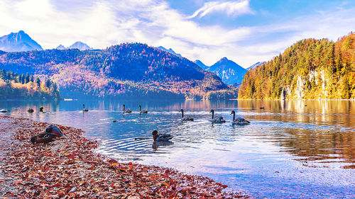 Scenic view of lake by mountains against sky