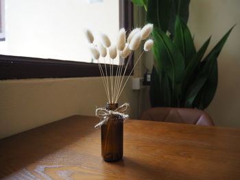 Close-up of flower vase on table at home