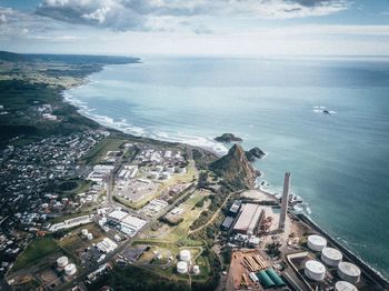 High angle view of sea and buildings against sky