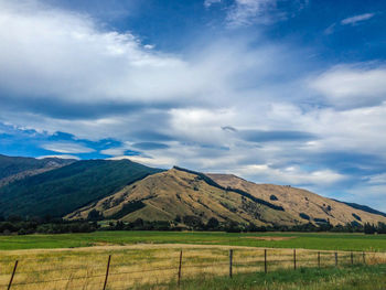 Scenic view of landscape and mountains against sky