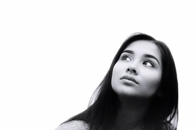 Close-up portrait of young woman over white background