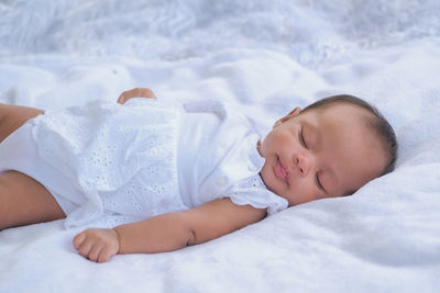 Cute baby lying on bed