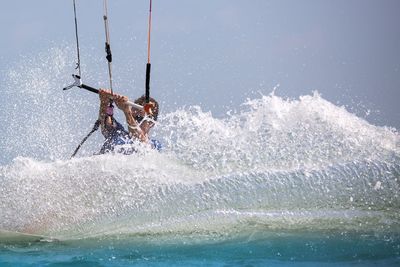 Man kiteboarding in sea