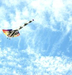 Low angle view of airplane flying against sky