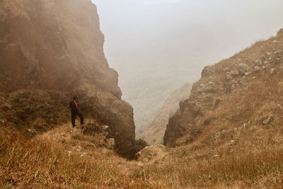 Man hiking on rock formation