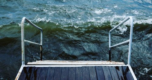 High angle view of ladder by sea