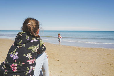 Young woman standing at beach