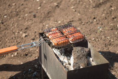 High angle view of meat on barbecue grill