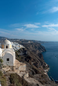 High angle view of buildings by sea against sky