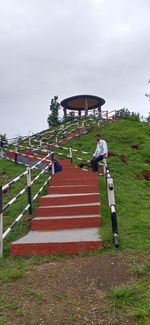 Staircase on field against sky