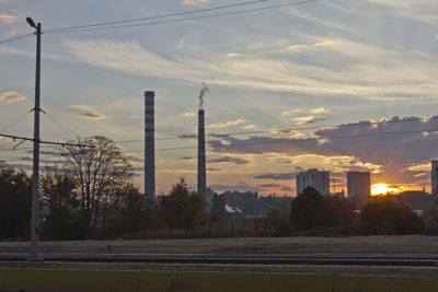 View of factory against sky during sunset