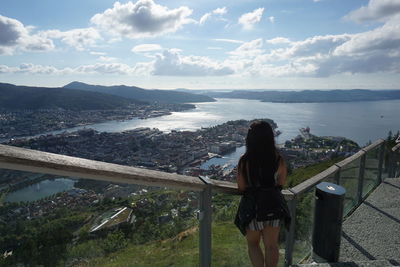 Rear view of woman looking at sea against sky