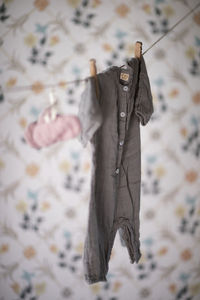 Close-up of clothes drying on clothesline against wall