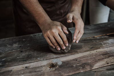 Close-up of artist making pot at workshop