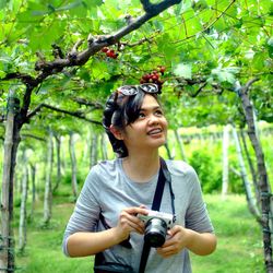 Young woman photographing at vineyard