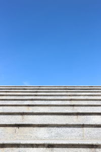 Low angle view of staircase against blue sky