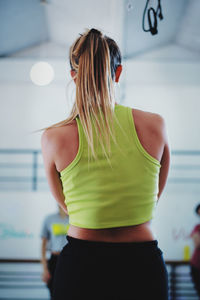 Rear view of woman exercising at gym