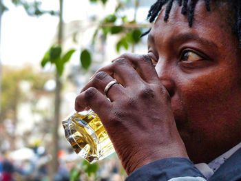 Close-up of woman drinking beer outdoors