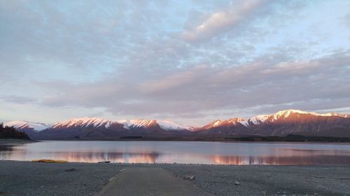 View of calm lake against cloudy sky