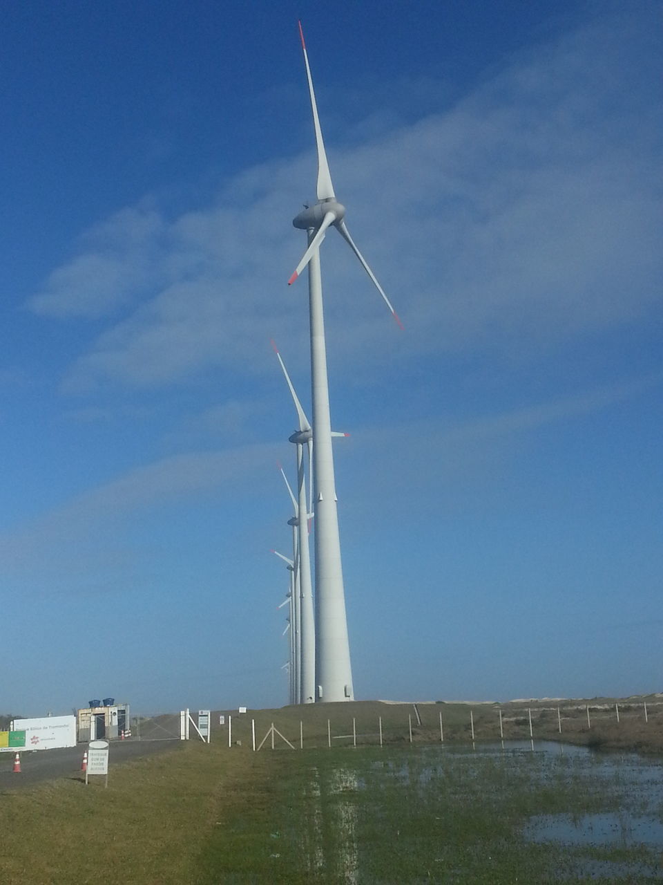 blue, alternative energy, wind power, wind turbine, renewable energy, environmental conservation, low angle view, windmill, sky, fuel and power generation, clear sky, day, airplane, built structure, vapor trail, nature, copy space, outdoors, transportation, no people