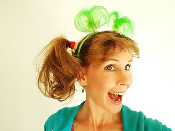 Portrait of young woman against white background