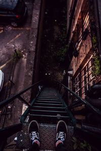 Low section of person standing on steps at night