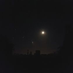 Silhouette landscape against sky at night