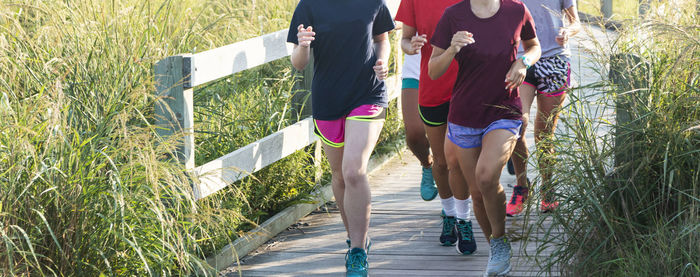 Low section of women running at park