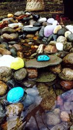 Close-up of pebbles on rocks at shore