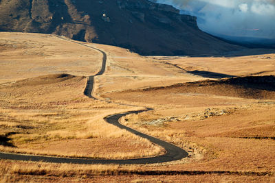 High angle view of road by mountains against sky