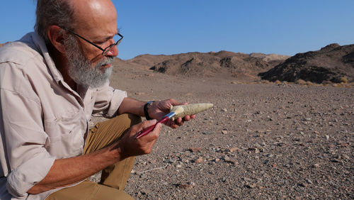 Archaeologist at work in the desert 