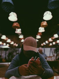 Woman using mobile phone in restaurant at night