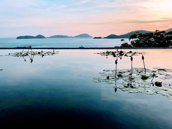 Scenic view of lake and sea against sky during sunset