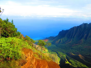 Scenic view of mountains against blue sky