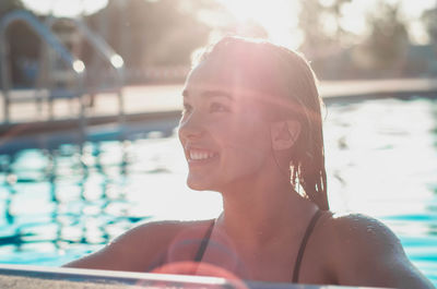 Young smiling woman in swimming pool