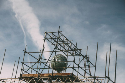 Low angle view of electricity pylon against sky