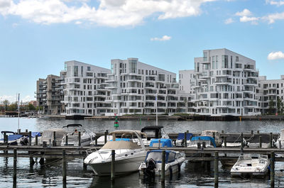 Boats in harbor with buildings in background