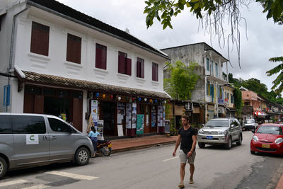 Cars on street by buildings in city