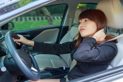 Portrait of woman sitting in car